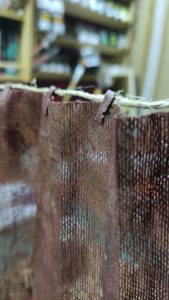 Proceso artesanal del diorama "El Nombre de la Rosa": recreación detallada de los baños del monasterio medieval con Berengario muerto en la bañera, modelado de texturas de piedra húmeda y envejecimiento de mobiliario de madera real